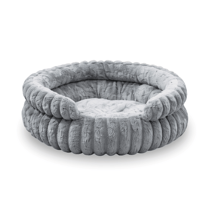 Rundes graues Plüsch Hundebett mit weichem erhöhtem Rand und gepolsterter Liegefläche.