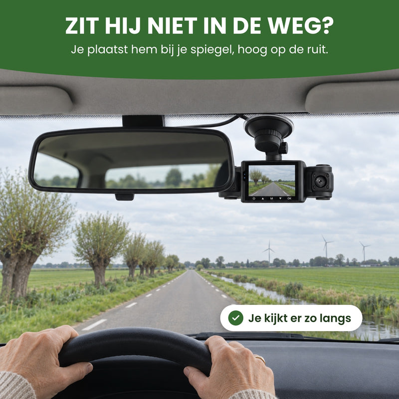 Die Dashcam VisionEdge 360 hängt teils hinter dem Innenspiegel, mit eingeschaltetem Display, über einer Landstraße: freie Sicht nach vorn